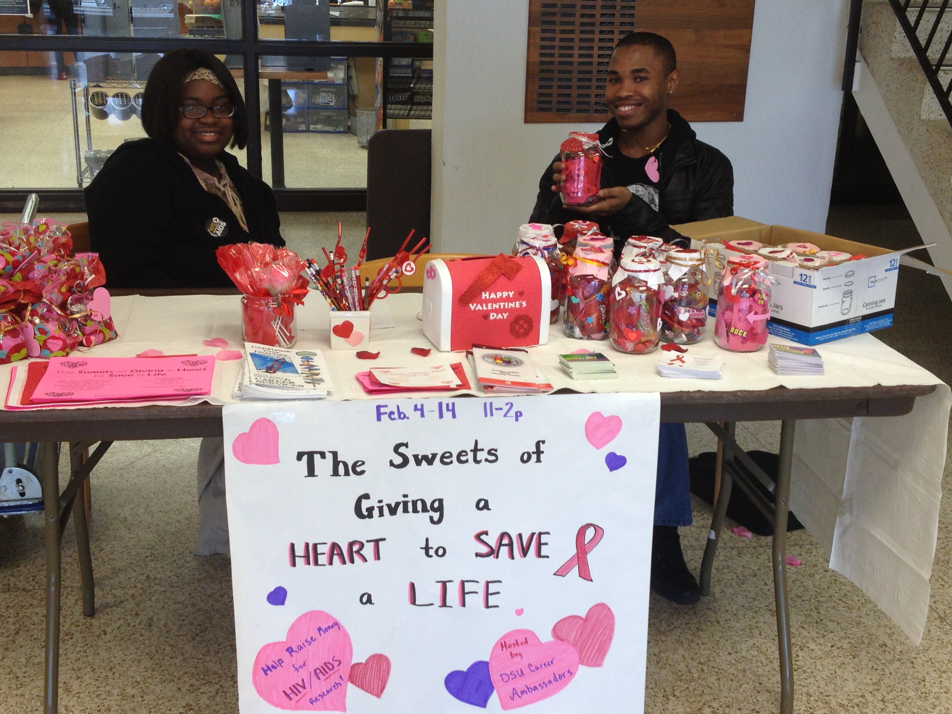 PHOTO: From left, Dolores Hemphill, senior child development major from Indianola, and Dimitrius Sneed, junior criminal justice major from Memphis sell Valentine’s Day gifts to raise funds for HIV/Aids awareness.